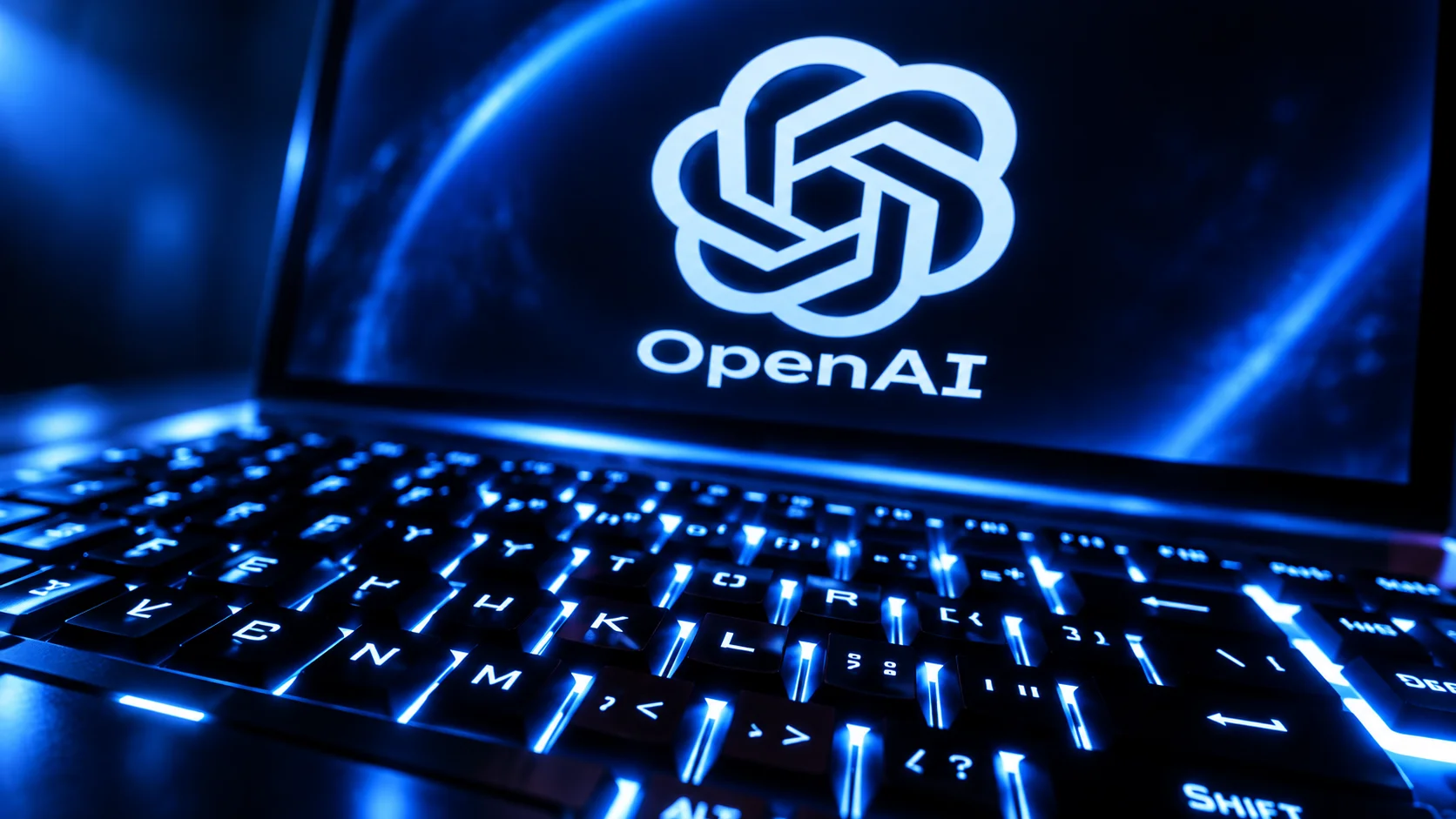 Laptop with a blue-lit keyboard and the OpenAI logo displayed on the screen.
