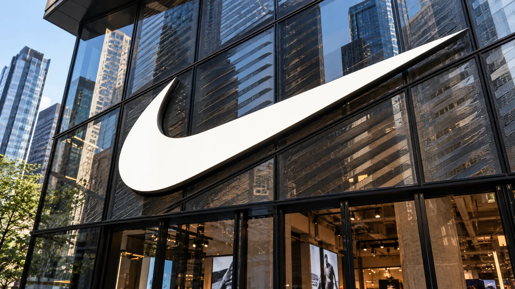 Nike logo prominently displayed on the facade of a store with a glass structure.