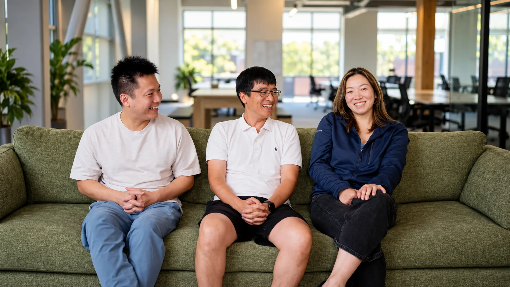 Three Nuance Labs members sitting on a sofa in a modern office.