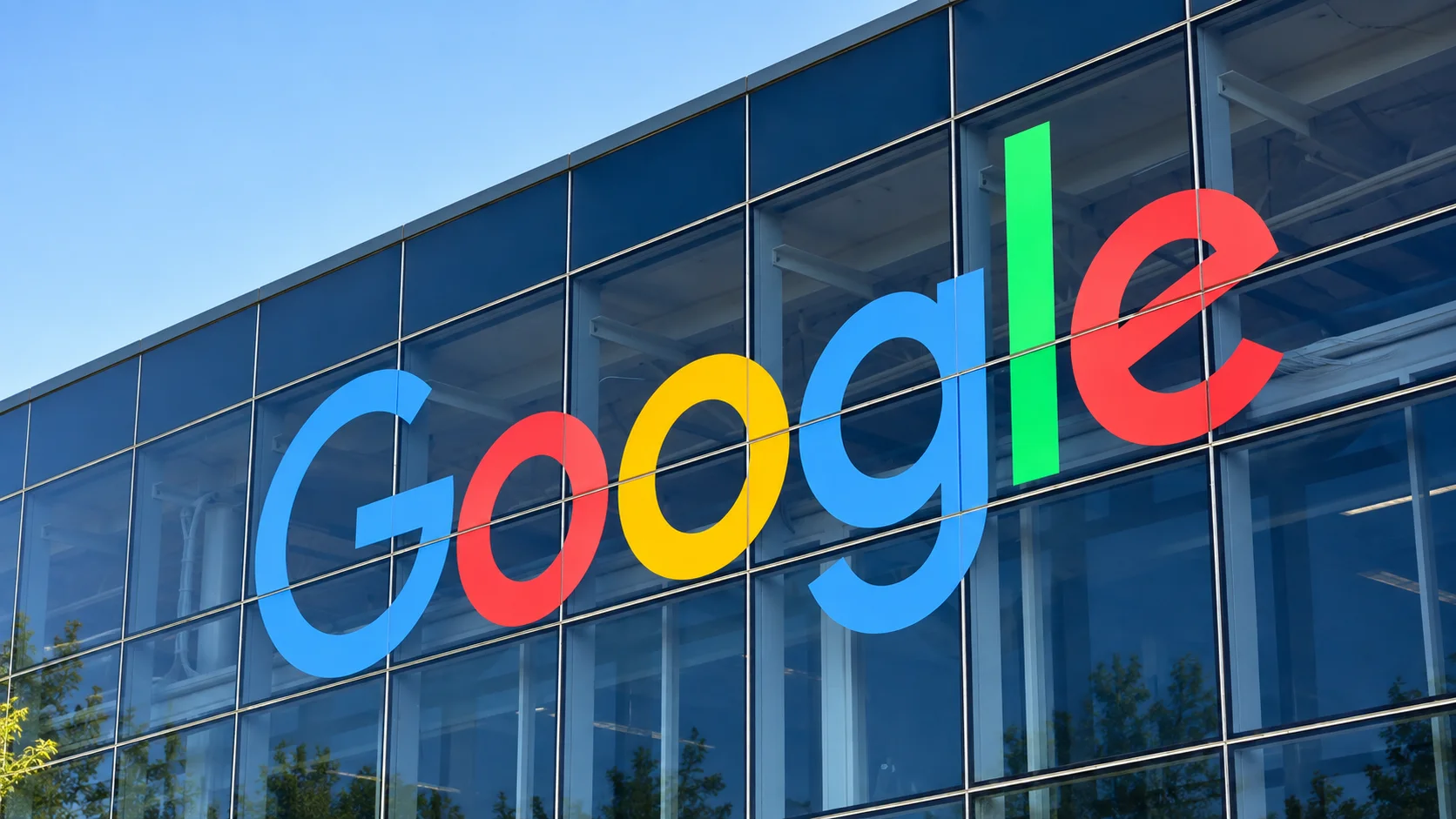 Colorful Google logo installed on the glass facade of a corporate building.