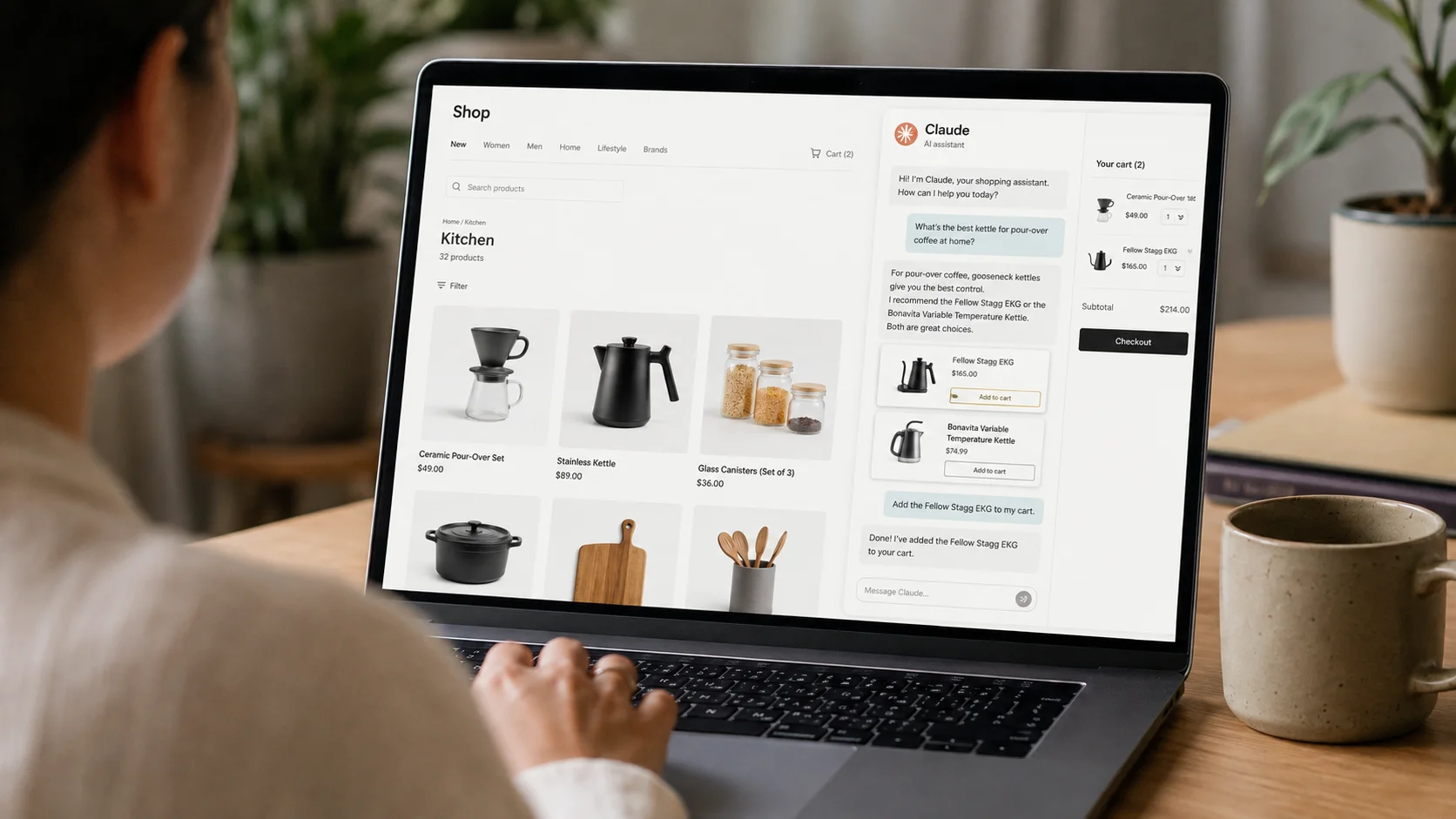 Person using a laptop to shop online on an e-commerce site with the AI assistant Claude, which recommends kitchen products and adds items to the cart.