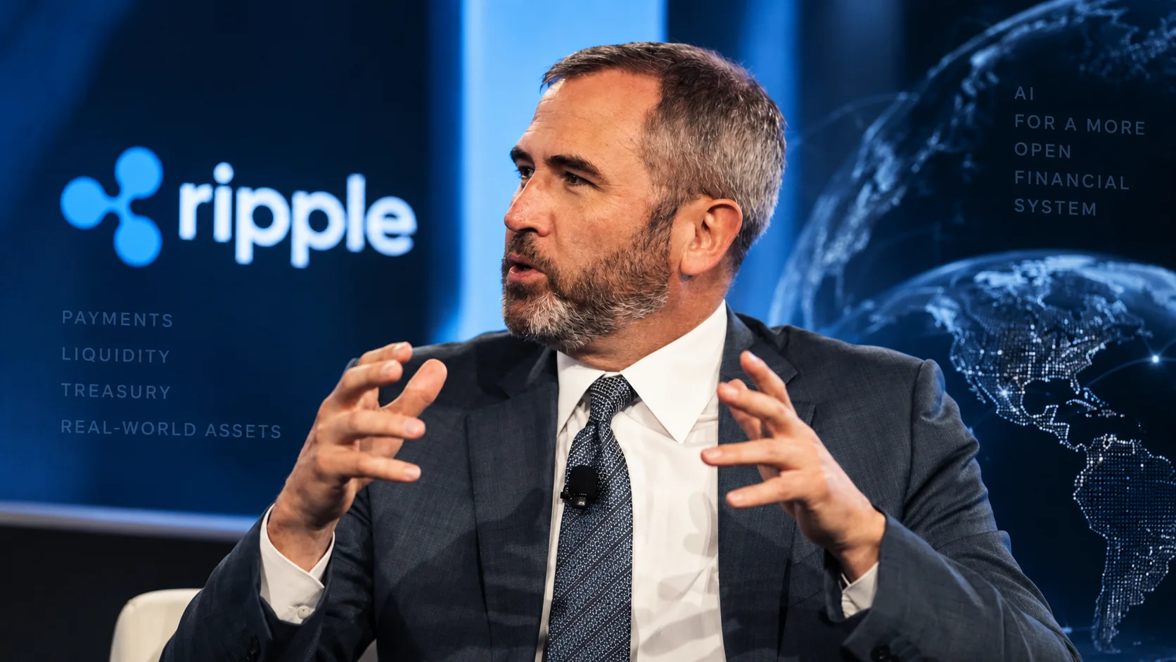 Ripple executive on a panel with the company's visual identity in the background.